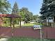 Charming exterior view, highlighted by a cute fence, mature trees, a mailbox with the property's address, and a shed at 2310 E Raymond St, Indianapolis, IN 46203