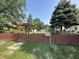 Charming exterior view, highlighted by a cute fence, mature trees, a mailbox with the property's address, and a shed at 2310 E Raymond St, Indianapolis, IN 46203