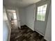 Hallway featuring faux wood floor, white walls, and a white door at the end at 2310 E Raymond St, Indianapolis, IN 46203