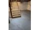 Basement staircase leading down to a concrete floor with brick foundation at , Beech Grove, IN 46107