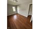 Bright bedroom featuring hardwood floors, a window, and neutral paint at , Beech Grove, IN 46107