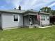 Charming home featuring an inviting front porch, gray siding, and an American flag at , Beech Grove, IN 46107