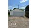 Exterior shot of a detached one-car garage with white siding and an asphalt driveway at , Beech Grove, IN 46107