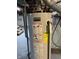 Kenmore water heater with visible warning labels and energy guide at , Beech Grove, IN 46107