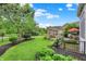 Beautiful backyard with a stone fireplace, lush greenery and a patio set at 2535 Dawn Ridge Dr, Westfield, IN 46074