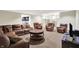 Finished basement boasts neutral colors, chair and couch seating, and open flow to the kitchen at 2535 Dawn Ridge Dr, Westfield, IN 46074