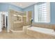 This bathroom features a stand up shower and a soaking tub next to a window at 2535 Dawn Ridge Dr, Westfield, IN 46074