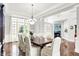 Elegant dining room with hardwood floors, large windows, and a stylish chandelier above the table at 2535 Dawn Ridge Dr, Westfield, IN 46074