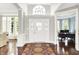 Elegant foyer with hardwood floors, a decorative rug, and a grand arched window above the front door at 2535 Dawn Ridge Dr, Westfield, IN 46074