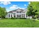 Stunning two-story white brick home with lush lawn, manicured landscaping, and beautiful curb appeal at 2535 Dawn Ridge Dr, Westfield, IN 46074