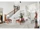 Spacious living room showcasing staircase and open entryway with neutral tones and stylish furnishings at 2535 Dawn Ridge Dr, Westfield, IN 46074