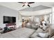 Open-concept living room with a modern TV setup and seamless transition to the kitchen at 2535 Dawn Ridge Dr, Westfield, IN 46074