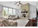 Cozy living room with stone fireplace, plush seating, and large windows for natural light at 2535 Dawn Ridge Dr, Westfield, IN 46074