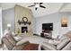 Bright living room featuring a stone fireplace, ceiling fan, and comfortable seating arrangement at 2535 Dawn Ridge Dr, Westfield, IN 46074
