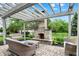 Covered stone patio with wood pergola, wicker furniture and outdoor fireplace at 2535 Dawn Ridge Dr, Westfield, IN 46074