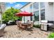 Cozy outdoor patio with stone fireplace, outdoor kitchen, and a dining table with chairs at 2535 Dawn Ridge Dr, Westfield, IN 46074