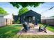 Charming backyard featuring a patio with outdoor seating, a well-maintained lawn, and mature trees at 2715 Northview Ave, Indianapolis, IN 46220