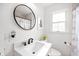 Bright bathroom with a white vanity, modern fixtures, framed mirror, and patterned shower curtain at 2715 Northview Ave, Indianapolis, IN 46220