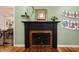 Close-up of the fireplace with black mantle and red brick hearth at 2715 Northview Ave, Indianapolis, IN 46220