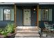 Inviting front porch with stone steps, wood pillars, and cozy seating area to enjoy at 2715 Northview Ave, Indianapolis, IN 46220