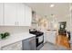 Modern kitchen with white cabinets, stainless steel appliances, and quartz countertops at 2715 Northview Ave, Indianapolis, IN 46220