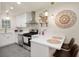 Bright kitchen features white cabinetry, stainless steel appliances and quartz countertops at 2715 Northview Ave, Indianapolis, IN 46220