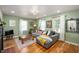 Bright living room with hardwood floors, fresh green paint, and a comfortable seating area at 2715 Northview Ave, Indianapolis, IN 46220