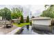Backyard featuring lush green grass, patio area, and detached garage at 28 N Elizabeth St, Indianapolis, IN 46219