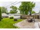 Well-maintained backyard with green grass, patio furniture, and detached garage at 28 N Elizabeth St, Indianapolis, IN 46219