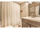 Cozy bathroom with a shower curtain, mirror, and vanity at 28 N Elizabeth St, Indianapolis, IN 46219