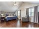 Vaulted ceiling primary bedroom with a ceiling fan, dark wood floors, and windows with curtains at 28 N Elizabeth St, Indianapolis, IN 46219