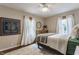 Bedroom with hardwood floors, ceiling fan, stylish light fixture, and natural light at 28 N Elizabeth St, Indianapolis, IN 46219