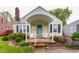 Charming home featuring a brick front porch with white Adirondack chairs and a light blue front door at 28 N Elizabeth St, Indianapolis, IN 46219