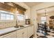 Bright and airy kitchen with white cabinetry, subway tile backsplash, and granite countertops adjacent to dining room at 28 N Elizabeth St, Indianapolis, IN 46219