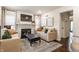 Comfortable living room featuring a fireplace, neutral-toned sofas, ottoman, and hardwood floors at 28 N Elizabeth St, Indianapolis, IN 46219