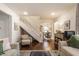 Spacious living room with hardwood floors, stairs, and open view into the dining room, creating an airy feel at 28 N Elizabeth St, Indianapolis, IN 46219