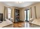Home office featuring hardwood floors, built-in bookcase, and natural light at 28 N Elizabeth St, Indianapolis, IN 46219