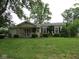 Charming single story home featuring a well-manicured lawn and a quaint front porch at 2825 Lucas Way, Columbus, IN 47203
