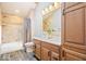 Bright bathroom features a double sink vanity, granite counters, wood cabinets and modern fixtures at 3295 Allison Ct, Carmel, IN 46033