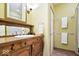 A full bathroom featuring antique wood vanity with sink, vintage framed mirror, and tiled flooring at 3295 Allison Ct, Carmel, IN 46033