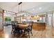 Spacious dining area flows into the kitchen, featuring wood floors and modern lighting at 3295 Allison Ct, Carmel, IN 46033