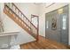 Elegant foyer with hardwood floors, a staircase, and a decorative front door with sidelights at 3295 Allison Ct, Carmel, IN 46033