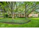 Beautiful brick home with mature trees, a green lawn, and a cozy front porch at 3295 Allison Ct, Carmel, IN 46033