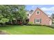 Well-manicured front lawn of a brick home, with a covered porch and beautiful green accents at 3295 Allison Ct, Carmel, IN 46033