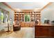 Well-appointed office with built-in bookshelves, wood desk, and comfortable seating at 3295 Allison Ct, Carmel, IN 46033