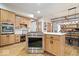 Open concept kitchen with an island, modern appliances, and warm wood cabinets and accents at 3295 Allison Ct, Carmel, IN 46033