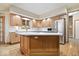 Well-lit kitchen boasts custom wood cabinetry, a center island, and modern stainless steel appliances at 3295 Allison Ct, Carmel, IN 46033