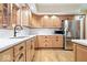 Bright kitchen featuring custom cabinetry, stainless steel appliances, and hardwood flooring at 3295 Allison Ct, Carmel, IN 46033