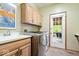 Convenient laundry room with modern washer and dryer, sink, and cabinet storage at 3295 Allison Ct, Carmel, IN 46033