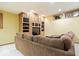 Living room with a large brown sofa and custom built in shelves with a tv at 3295 Allison Ct, Carmel, IN 46033